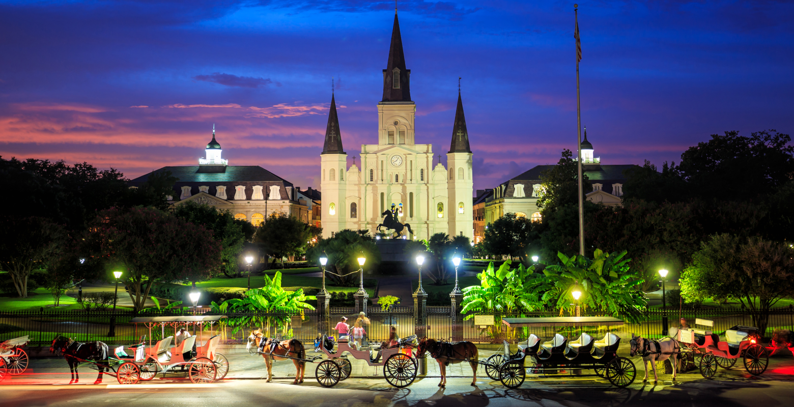 Horse Carriages line up the road in front of St. Louis Cathedral in the French Quarter